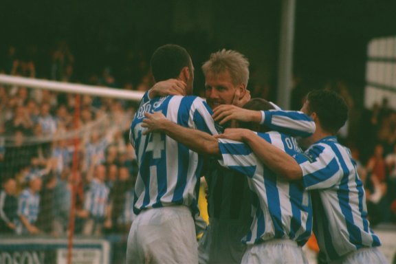 Players congratulate rogers, Lincoln city game 18 March 2000