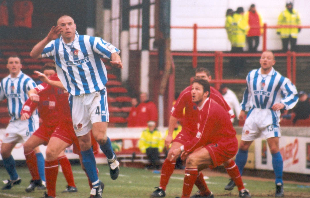 Cullip cups his ear to the quiet Orient fans, or jumps for a header, Leyton Orient game 03 march 2001