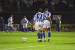 Hart and Zamora as Steele poses for the cameras in the background